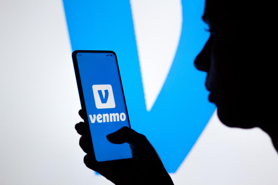 BRAZIL - 2022/04/21: In this photo illustration, a silhouetted woman holds a smartphone with the Venmo logo displayed on the screen. (Photo Illustration by Rafael Henrique/SOPA Images/LightRocket via Getty Images)