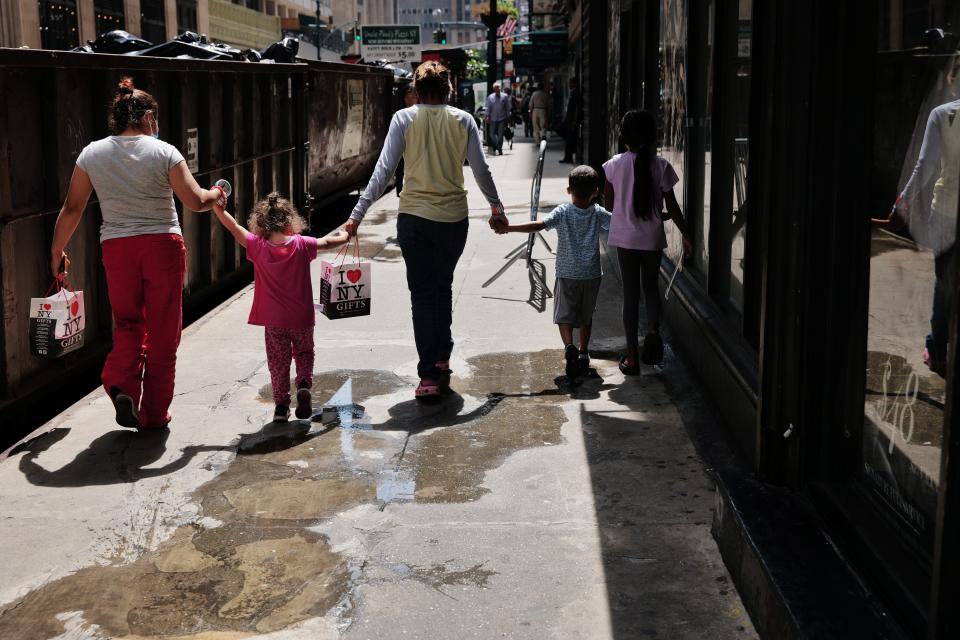 Recently arrived migrants gather outside of the Roosevelt Hotel in New York City on August 14, 2023 in New York City.