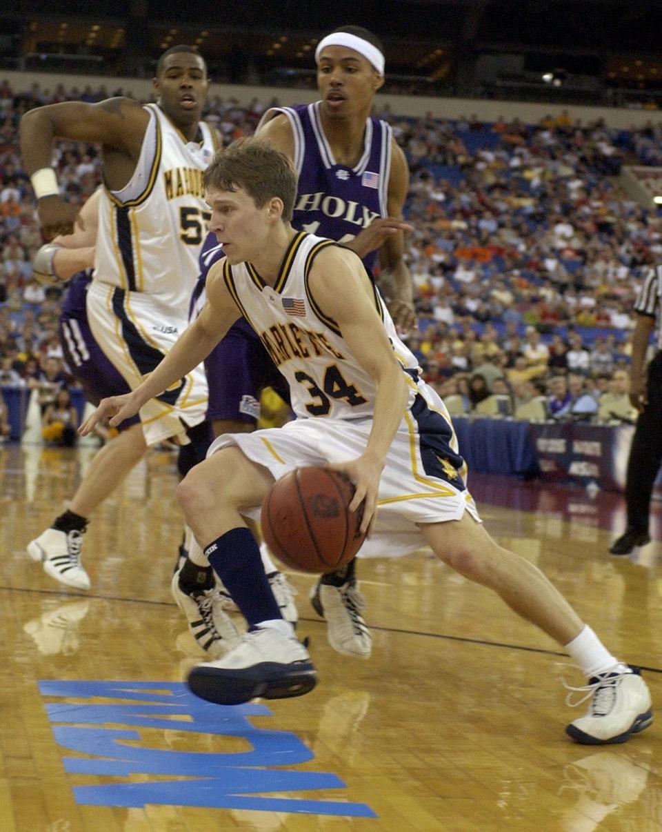 Marquette's Travis Diener drives past a Holy Cross defender in the first round of the NCAA tournament at the RCA Dome in Indianapolis.