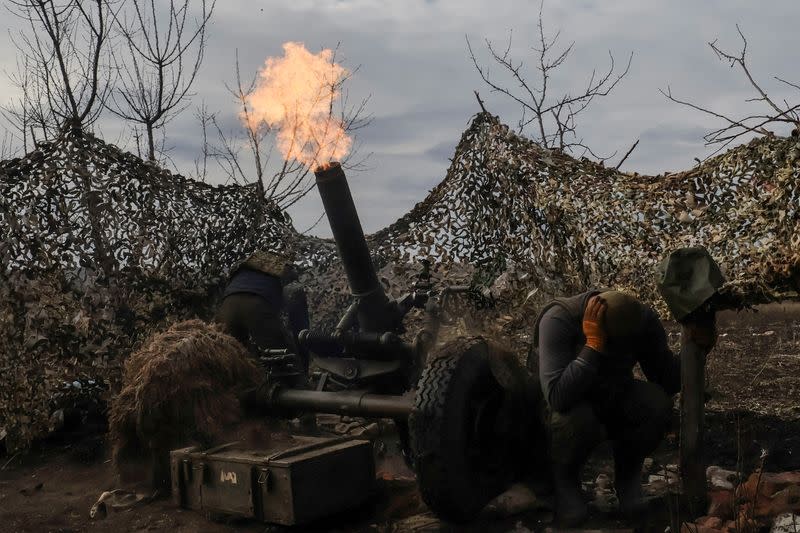 FILE PHOTO: Ukrainian service members fire a mortar towards Russian troops outside the frontline town of Bakhmut