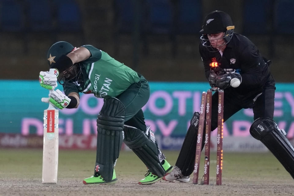 Pakistan's Mohammad Rizwan, left, is bowled out by New Zealand's Mitchell Santner during the second one-day international cricket match between Pakistan and New Zealand, in Karachi, Pakistan, Wednesday, Jan. 11, 2023. (AP Photo/Fareed Khan)