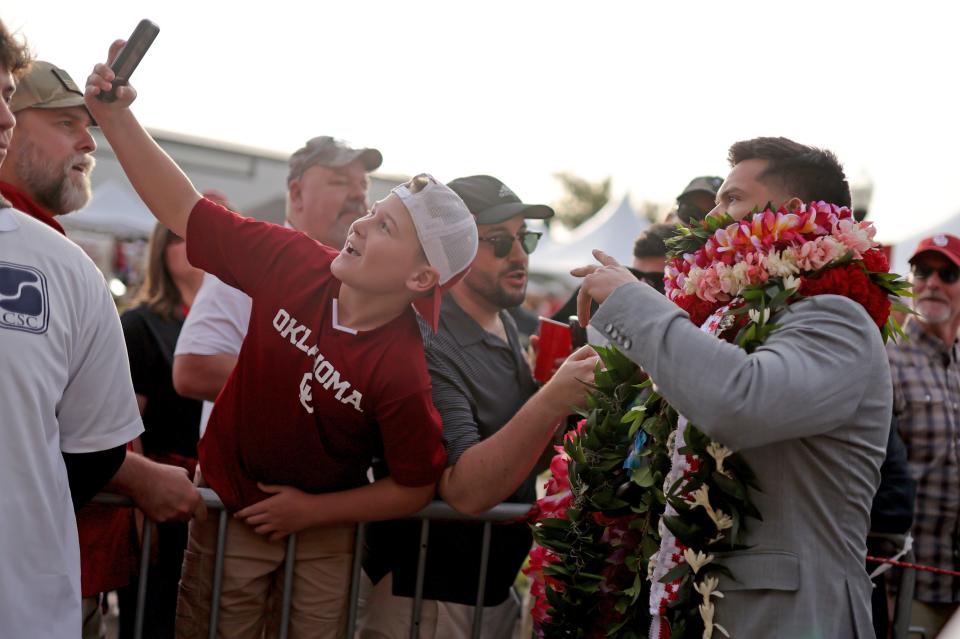 Oklahoma's Dillon Gabriel (8) takes a picture with fans at the Walk of Champions before the college football game between the University of Oklahoma Sooners and the University of Central Florida Knights at Gaylord Family-Oklahoma Memorial Stadium in Norman, Okla., Saturday, Oct., 21, 2023.