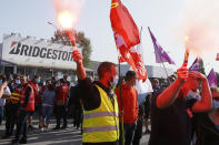 Bridgestone employees gather outside the tire factory of Bethune, northern France, Thursday, Sept.17, 2020. Workers protest over the Japan-based company's decision to close the plant and lay off all its nearly 900 workers. Bridgestone argues the factory is no longer competitive globally, but unions and French politicians accused the company of using the virus-driven economic crisis as a pretext for the closure and not investing in modernizing the plant instead. (AP Photo/Michel Spingler)