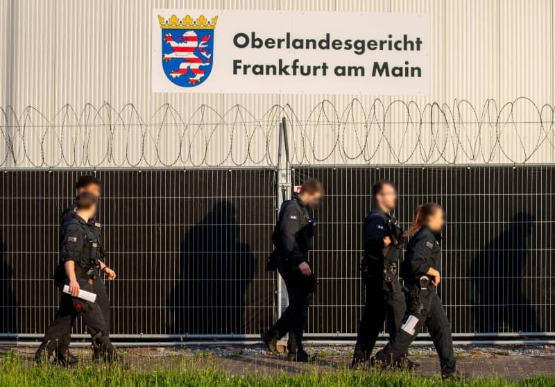 Police officers walk before the Oberlandesgericht Frankfurt ahead of the second and most high-profile trial linked to a far-right coup plot in Germany, with the alleged 72-year-old leader, Prince Heinrich XIII of Reuss, going on trial.  court.  Helmut Fricke/dpa