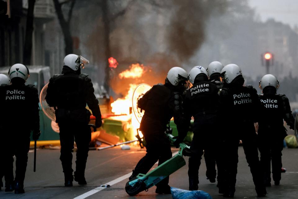 Belgian riot police stand in position as clashes erupt during a demonstration against Belgian government's measures to curb the spread of the Covid-19 and mandatory vaccination in Brussels on December 5, 2021.  Belgian schools will require children aged six and above to wear masks because of 