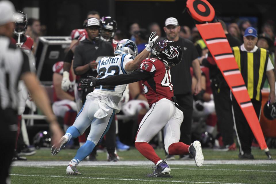 Carolina Panthers running back Christian McCaffrey (22) hits Atlanta Falcons linebacker Deion Jones (45) during the second half of an NFL football game, Sunday, Dec. 8, 2019, in Atlanta. (AP Photo/Danny Karnik)