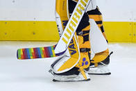 FILE - Los Angeles Kings goaltender Calvin Petersen (40) holds a stick wrapped in rainbow tape for Pride night while warming up before an NHL hockey game Monday, April 26, 2021, in Los Angeles. At least one National Hockey League team with a Russian player on its roster has decided against wearing special warmup jerseys to commemorate Pride Night because of a Russian law that expands restrictions on activities seen as promoting LGBTQ rights. (AP Photo/Ashley Landis, File)