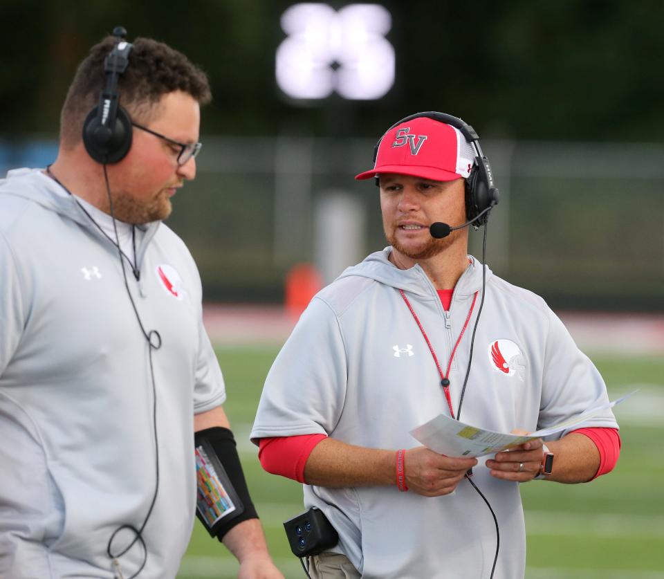 Brian Gamble (right), talking on the sideline during a 2022 football game against Fairless, is Sandy Valley's baseball and football coach.