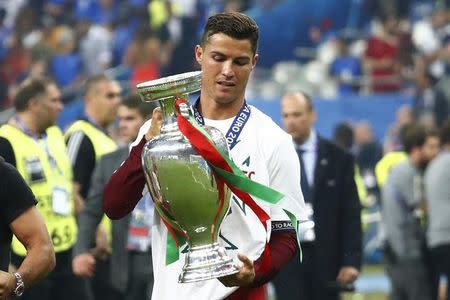 Football Soccer - Portugal v France - EURO 2016 - Final - Stade de France, Saint-Denis near Paris, France - 10/7/16 Portugal's Cristiano Ronaldo celebrates with the trophy after winning Euro 2016 REUTERS/Michael Dalder/ Livepic