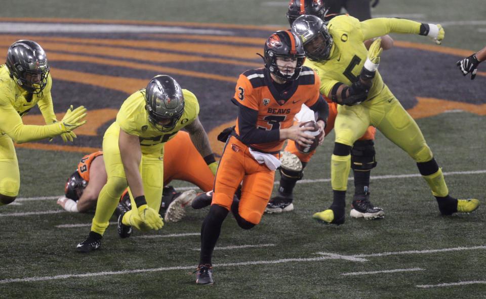 Oregon State’s Tristan Gebbia scrambles for yardage against Oregon.