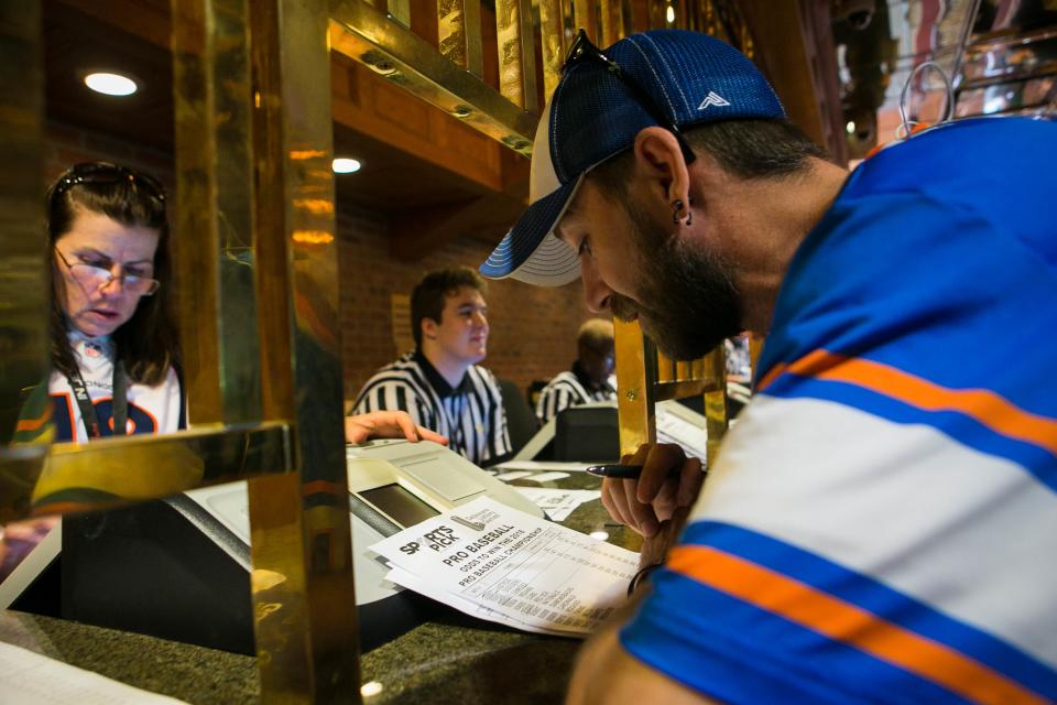 Brian Pfeffer of Wilmington places his bets on the Yankees, Warriors, Knights, Cubs and Tigers. At 1:30 p.m. today Tuesday, June 5, 2018, Delaware launches the country's first full-scale sports betting operation outside of Nevada as people roll into the Casino at Delaware Park in Stanton, Del. to wager their bets.