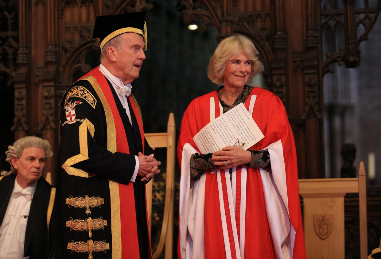 CHESTER, UNITED KINGDOM - MARCH 16:  Camilla, Duchess of Cornwall receives her honorary doctorate from the Chancellor of the University of Chester Gyles Brandreth (L) during the University of Chester's graduation ceremony in Chester Cathedral where she received an honorary doctorate in recognition of her commitment to promoting literacy and celebrating literature on March 16, 2018 in Chester, England. (Photo by Peter Byrne - WPA Pool/Getty Images)