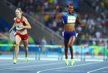 2016 Rio Olympics - Athletics - Final - Women's 400m Hurdles Final - Olympic Stadium - Rio de Janeiro, Brazil - 18/08/2016. Dalilah Muhammad (USA) of USA runs ahead of Sara Slott Petersen (DEN) of Denmark. REUTERS/Lucy Nicholson