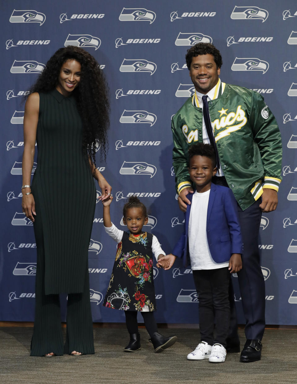 Seattle Seahawks NFL football quarterback Russell Wilson poses for photos with his wife Ciara, their daughter Sienna, and Ciara's son Future, Wednesday, April 17, 2019, in Renton, Wash., following a press conference. Earlier in the week, Wilson signed a $140 million, four-year extension with the team. (AP Photo/Ted S. Warren)