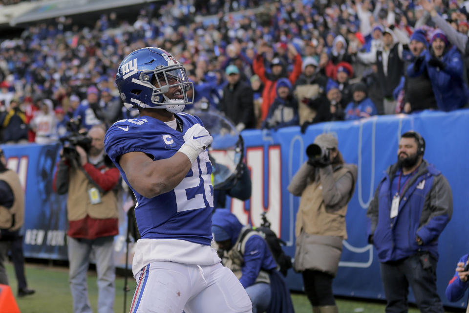 New York Giants running back Saquon Barkley (26) reacts after scoring touchdown against the Miami Dolphins during the third quarter of an NFL football game, Sunday, Dec. 15, 2019, in East Rutherford, N.J. (AP Photo/Seth Wenig)