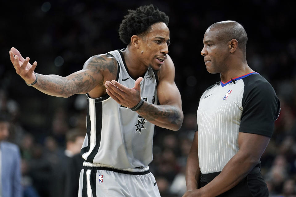 FILE - San Antonio Spurs' DeMar DeRozan, left, talks to official Tony Brown during the first half of an NBA basketball game against the Los Angeles Clippers, Saturday, Dec. 21, 2019, in San Antonio. NBA referee Tony Brown, who was diagnosed with Stage 4 pancreatic cancer in March, says his treatment is going well and he’s hopeful of possibly returning to the court at some point this season. (AP Photo/Darren Abate, File)