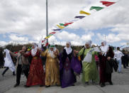 Women dance as thousands of supporters of pro-Kurdish Peoples' Democratic Party, or HDP, gather to celebrate the Kurdish New Year and to attend a campaign rally for local elections that will test the Turkish president's popularity, in Istanbul, Sunday, March 24, 2019. The HDP held the event amid the municipal office races that have become polarizing and a government crackdown on its members for alleged links to outlawed Kurdish militants. (AP Photo/Emrah Gurel)