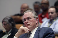 Pacific Gas and Electric Company (PG&E) CEO Bill Johnson listens to speakers during a California Public Utilities Commission meeting in San Francisco, Friday, Oct. 18, 2019. (AP Photo/Jeff Chiu)