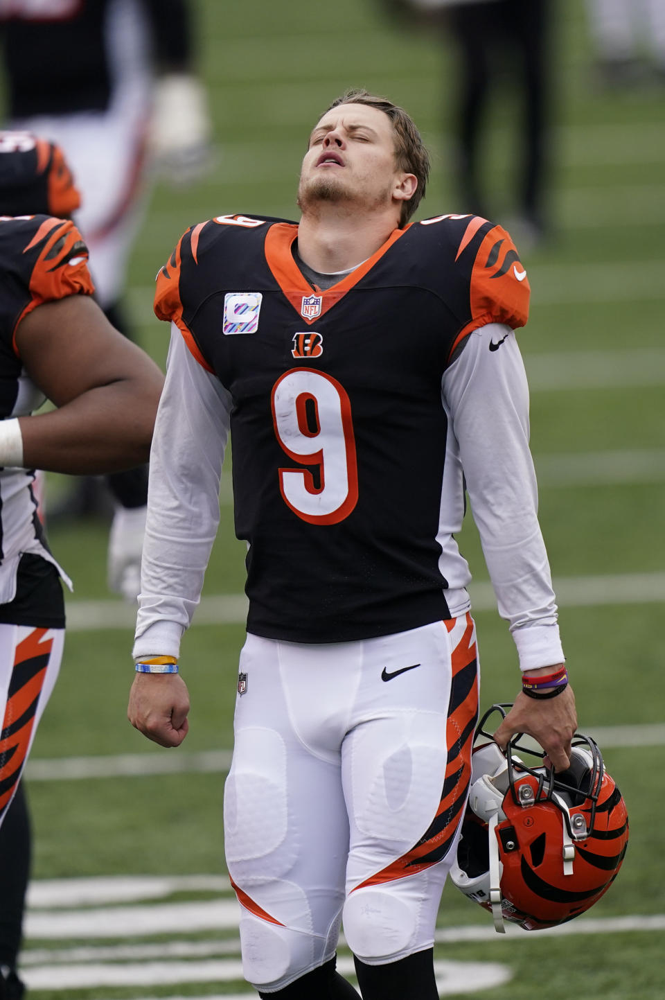 Cincinnati Bengals quarterback Joe Burrow (9) walks off the field following an NFL football game against the Cleveland Browns, Sunday, Oct. 25, 2020, in Cincinnati. (AP Photo/Bryan Woolston)