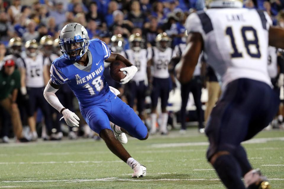 Oct 14, 2021; Memphis, Tennessee, USA; Memphis Tigers wide receiver Eddie Lewis (18) runs after a catch for a first down during the first half against the Navy Midshipmen at Liberty Bowl Memorial Stadium. Mandatory Credit: Petre Thomas-USA TODAY Sports