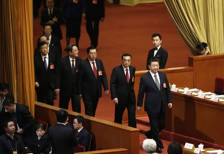 China's President Xi Jinping (R), Premier Li Keqiang (behind Xi) and other leaders, China's Politburo Standing Committee members (3rd R-L), Zhang Dejiang, Yu Zhengsheng, Liu Yunshan, Wang Qishan and Zhang Gaoli arrive for a plenary meeting of the National People's Congress (NPC), China's parliament, at the Great Hall of the People in Beijing, March 8, 2015. REUTERS/Jason Lee