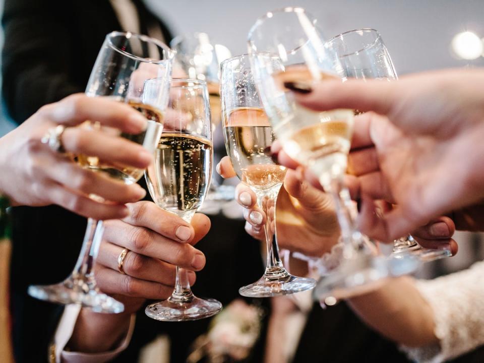 Champagne cups toasting during a wedding.