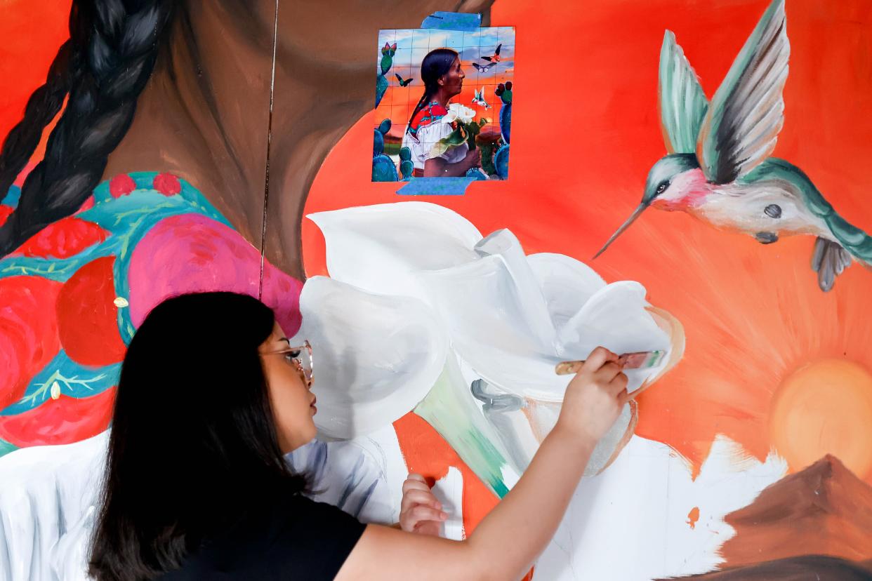Adamaris Rodriguez works March 4 on her piece "Para Adelante" for the Fresh Paint mural project.