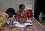 Ambika Chatterjee studies inside her house in Kolkata