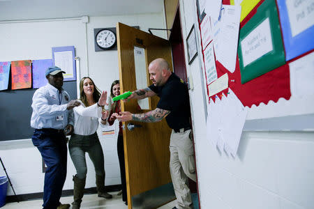 Teachers and staff members take part in an active shooter training at James I O'Neill High School in Highland Falls, New York, U.S., December 12, 2017. REUTERS/Eduardo Munoz