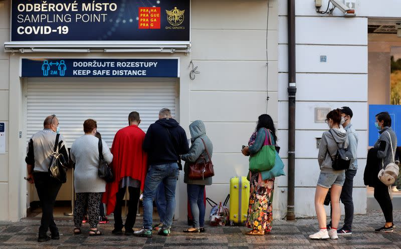 People wait in a line to get tested for the coronavirus disease in Prague