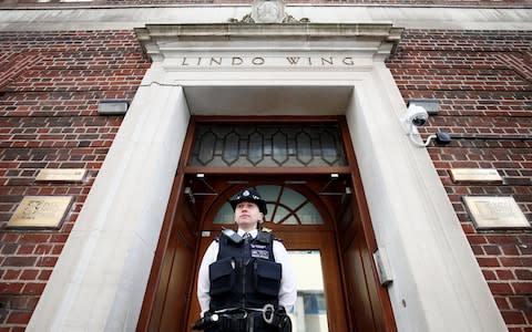 A police officer stands outside the Lindo Wing  - Credit: HENRY NICHOLLS /Reuters