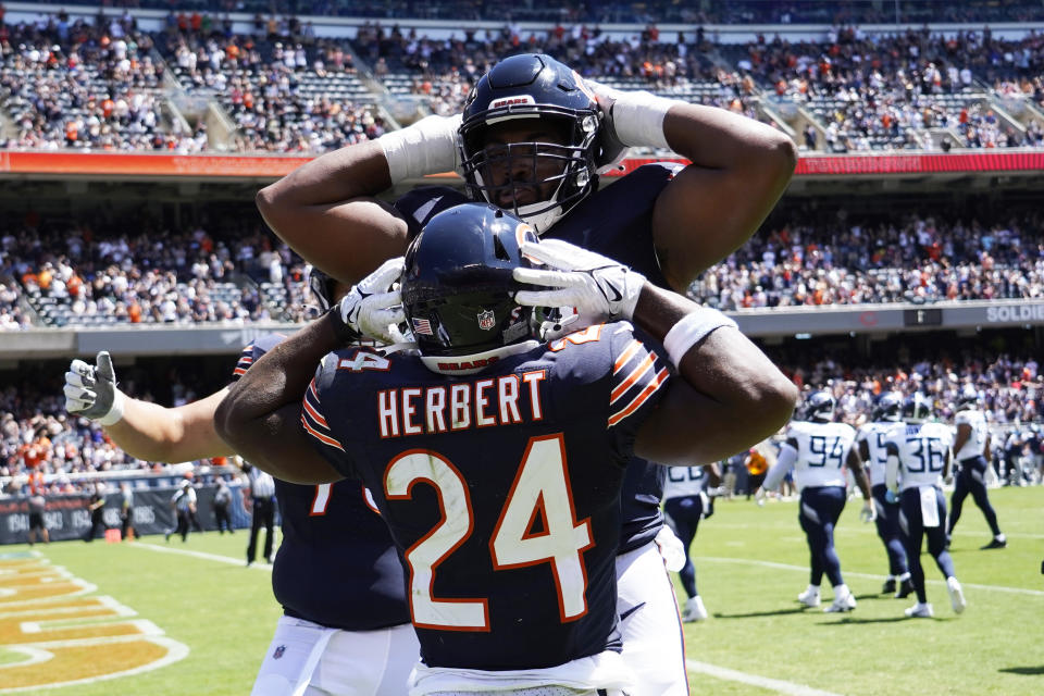 Aug 12, 2023; Chicago, Illinois, USA; Chicago Bears running back Khalil Herbert (24) celebrates his touchdown against the Tennessee Titans with offensive tackle <a class="link " href="https://sports.yahoo.com/nfl/players/34124" data-i13n="sec:content-canvas;subsec:anchor_text;elm:context_link" data-ylk="slk:Braxton Jones;sec:content-canvas;subsec:anchor_text;elm:context_link;itc:0">Braxton Jones</a> (70) at Soldier Field. Mandatory Credit: David Banks-USA TODAY Sports ORG XMIT: IMAGN-710965 ORIG FILE ID: 20230812_szo_bb6_0023 .JPG