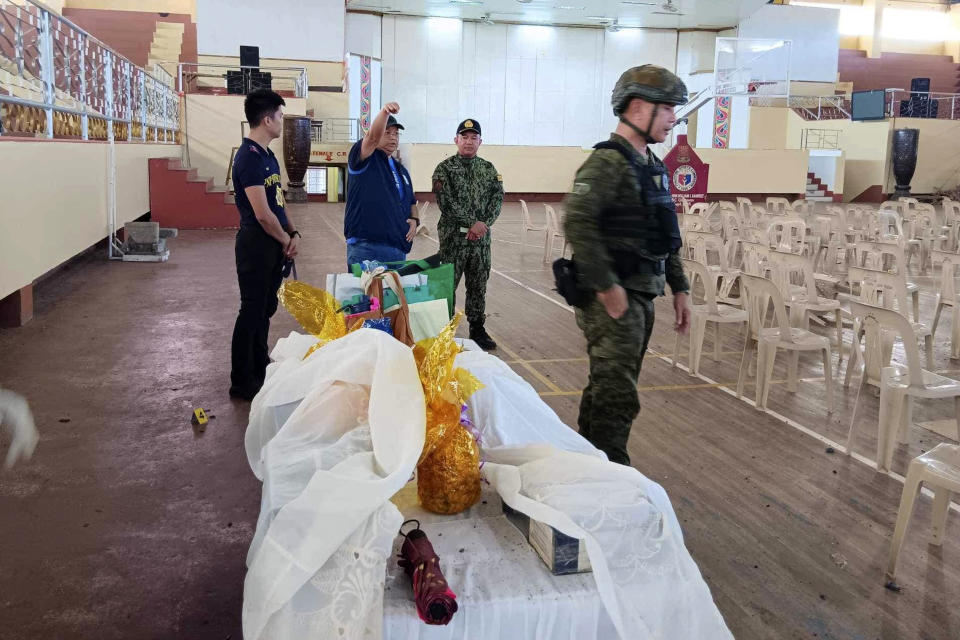 In this handout photo provided by the Provincial Government of Lanao Del Sur - Public Information Office, Governor Mamintal Bombit Alonto Adiong, Jr. second from left, talks with law enforcers at the site of an explosion in Marawi city, southern Philippines on Sunday Dec. 3, 2023. A powerful explosion believed caused by a bomb ripped through a Catholic Mass and killed several people and wounded dozens of others Sunday in a predominantly Muslim city in the southern Philippines, officials said. (Provincial Government of Lanao Del Sur - Public Information Office via AP)