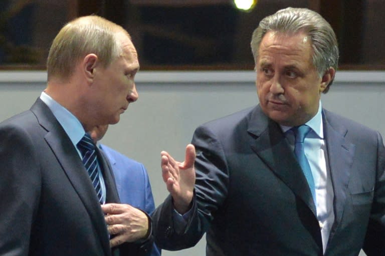 Russian President Vladimir Putin (L) listening to Sports Minister Vitaly Mutko as they visit a sports centre in Sochi