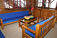 <p>The villa features Caribbean architecture with all-wood, open-concept spaces. Here’s the sitting area. <br> There’s also more than 1000 square feet of balconies and terraces, as well as a 700-square-foot great room. <br> (Airbnb) </p>