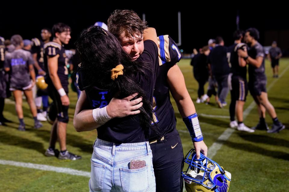 Cayden greets his girlfriend, Kinley Isbell, after the game. His team lost, but he had much to celebrate.