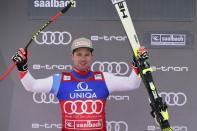 Switzerland's Beat Feuz celebrates his second place in a alpine ski, men's World Cup downhill, in Saalbach, Austria, Thursday, Feb. 13, 2020. (AP Photo/Marco Tacca)