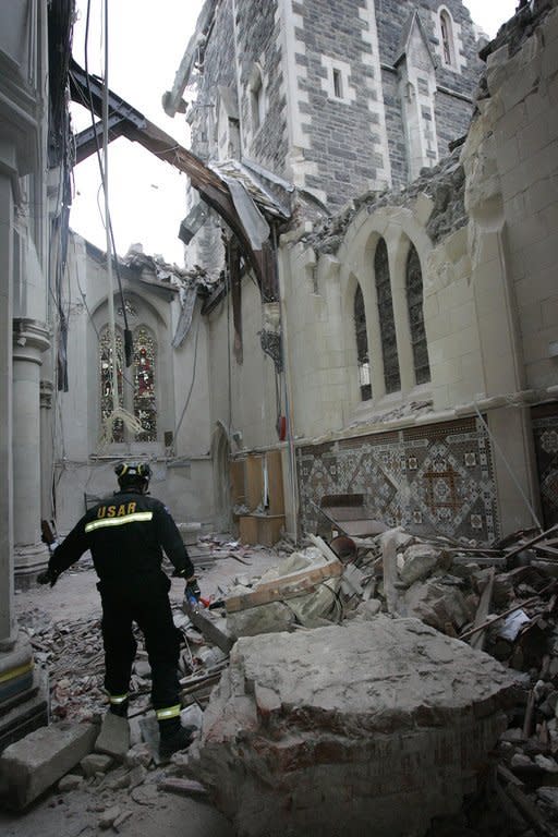 This picture taken on February 28, 2011 shows rescue personnel inside the main room in Christchurch Cathedral, six days after it was destroyed in an earthquake. Church authorities envisage the cardboard replacement being used as a cathedral for only 10 years, until a permanent structure is built