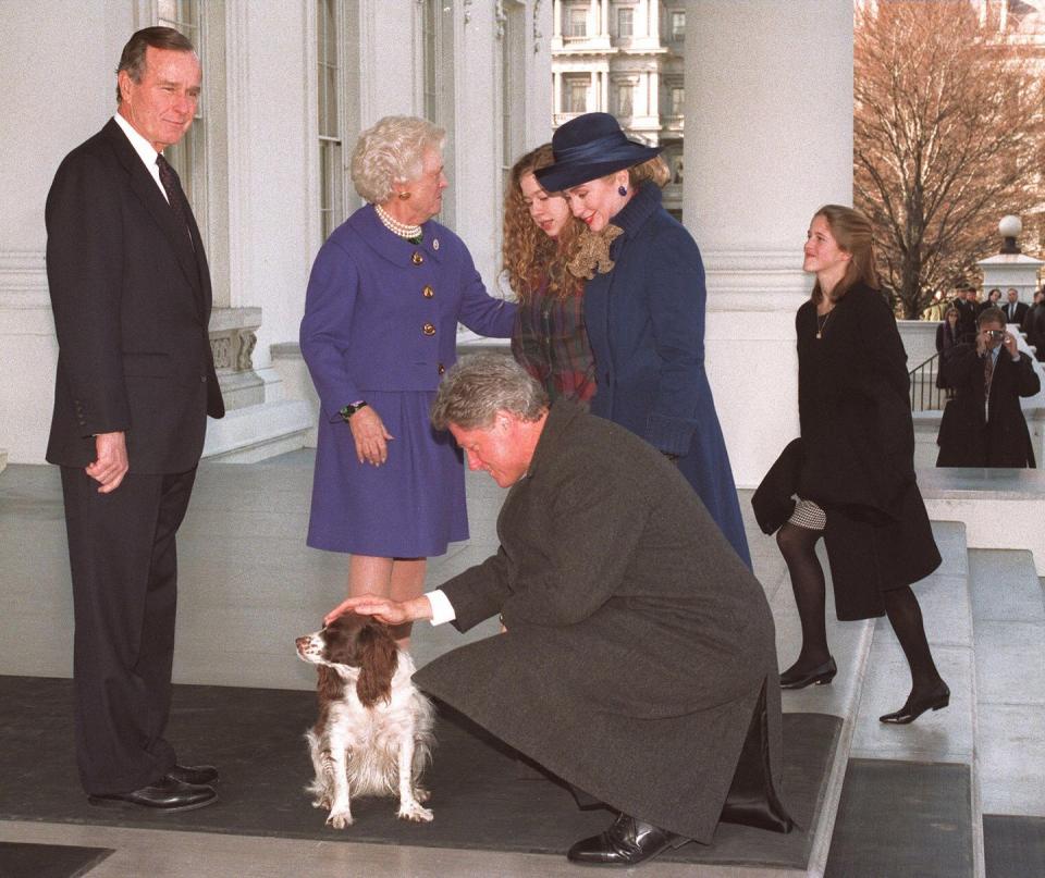 <p>President George Bush at the steps of the White House watches as President-elect Bill Clinton pets the Bush family's dog Millie as First Lady Barbara Bush greets Hillary Clinton. The Clintons and Bushes rode to the Capitol together for Clinton' swearing-in as the 42nd president of the United States on January 20, 1993.</p>