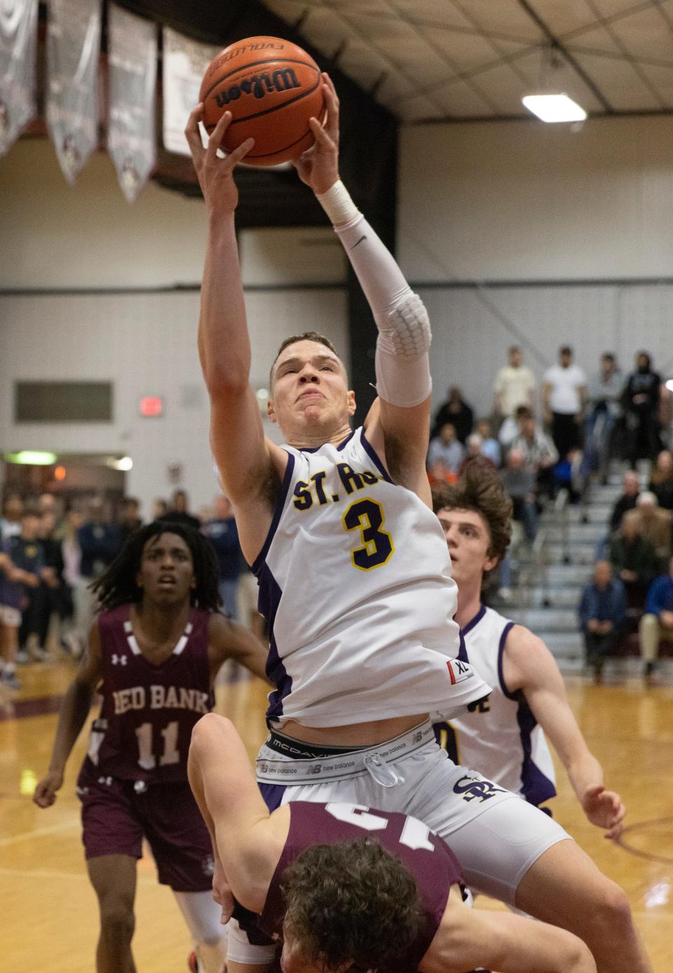 St. Rose  Matt Hodge comes down with a rebound in first half action. St Rose Boys Basketball vs Red Bank Regional in BUC Basketball Classic in Red Bank NJ on December 30, 2022. 