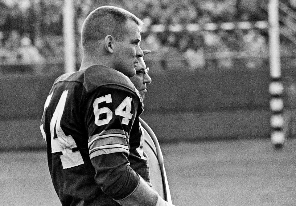 Green Bay Packers offensive guard Jerry Kramer and coach Vince Lombardi watch the Packers' defense against the San Francisco 49ers during their game at Milwaukee County Stadium on November 24, 1963. The Packers won 28-10.