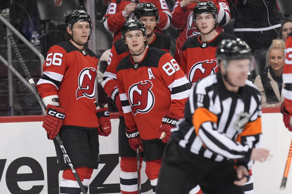 New Jersey Devils' Jack Hughes (86), center, celebrates his goal with teammates during the second period of an NHL hockey game against the Seattle Kraken in Newark, N.J., Monday, Feb. 12, 2024. (AP Photo/Seth Wenig)