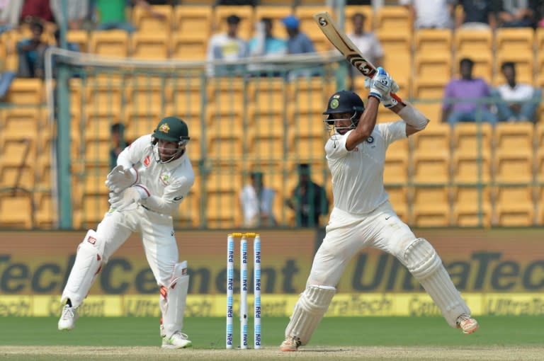 India batsman Cheteshwar Pujara plays a shot as Australia wicket keeper Matthew Wade looks on during third day of the second Test at The M. Chinnaswamy Stadium in Bangalore on March 6, 2017