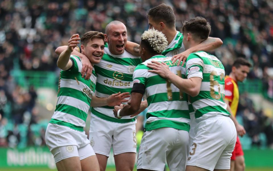 The Celtic team celebrate their win over Partick Thistle - PA