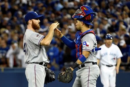 Oct 8, 2015; Toronto, Ontario, CAN; Texas Rangers relief pitcher Jake Diekman (41) celebrates with catcher Robinson Chirinos (61) after defeating the Toronto Blue Jays in game one of the ALDS at Rogers Centre. Mandatory Credit: Peter Llewellyn-USA TODAY Sports