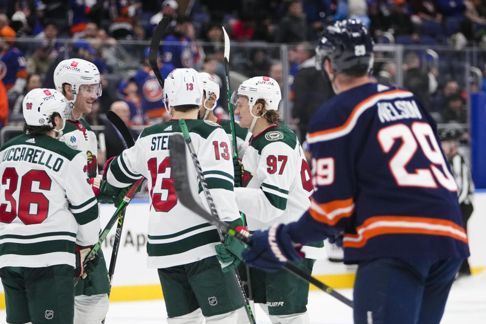 Minnesota Wild's Kirill Kaprizov (97) celebrates with teammates after scoring a goal against the New York Islanders during the third period of an NHL hockey game Thursday, Jan. 12, 2023, in Elmont, N.Y. The Wild won 3-1. (AP Photo/Frank Franklin II)