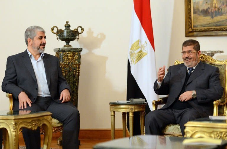 Egyptian President Mohamed Morsi (R) meets with Hamas leader Khaled Meshaal in Cairo on January 9, 2013. Palestinian president Mahmud Abbas and Meshaal have agreed to expedite a stalled reconciliation deal between the rival factions, a Hamas official said Thursday