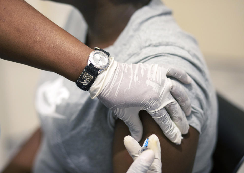Sisi Ndebele, receives a seasonal influenza vaccine from a nurse at a local pharmacy clinic in Johannesburg, South Africa on Friday, April 24, 2020. Ordinarily, South Africa sees widespread influenza during the winter months, but this year almost none have been found — something unprecedented. School closures, limited public gatherings and calls to wear masks and wash hands have “knocked down the flu,” said Dr. Cheryl Cohen, head of the institute's respiratory program. (AP Photo/Themba Hadebe)