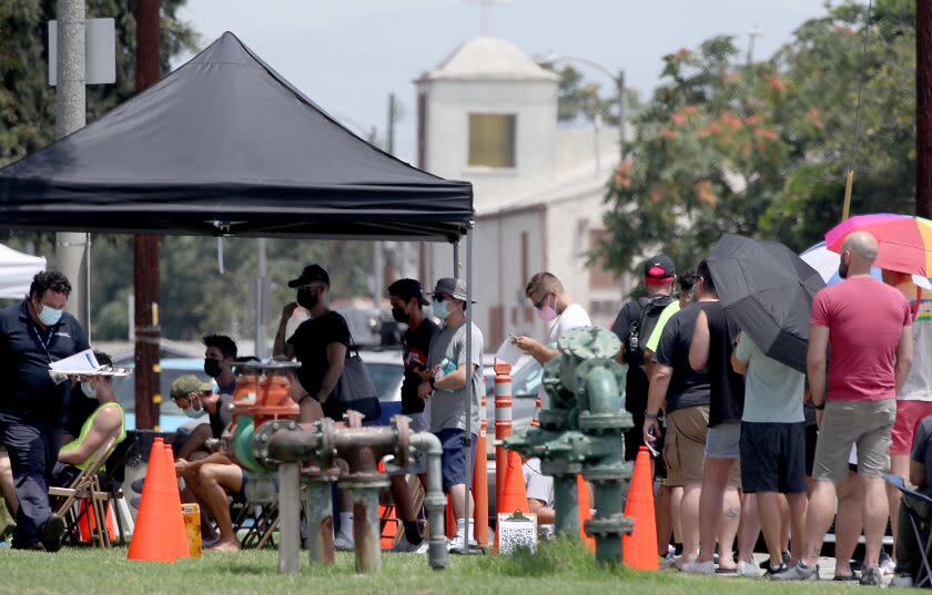 LOS ANGELES, CALIF. - JULY 21, 2022. People line up get vaccinated against the monkeypox virus on Thursday, July 21, 2022, at Ted Watkins Park in Watts. (Luis Sinco / Los Angeles Times)