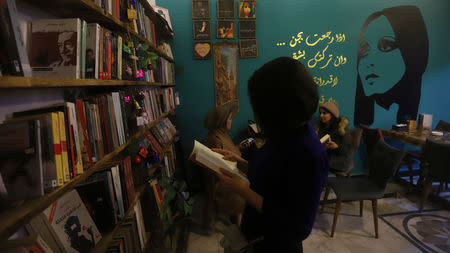 An Iraqi woman reads a book at a cafe called Fayruz Cafe after the famous female Lebanese singer Fayruz, in Basra, Iraq December 29, 2018. Picture taken December 29, 2018. REUTERS/Essam al-Sudani